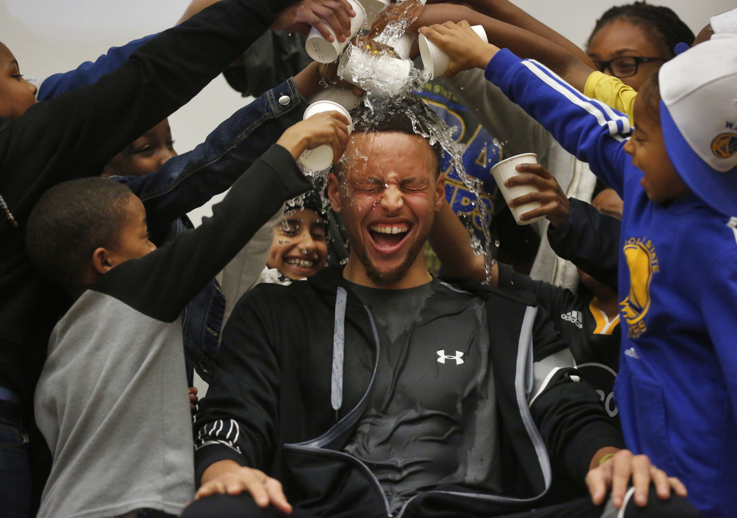 Students pour water onto Stephen Curry's head during an event at Martin Luther King Jr. Elementary School wherein Curry promoted drinking water and healthy eating in partnership with his sponsor Brita March 8, 2016 in Oakland, Calif.