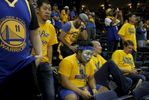 Warriors fans sit in stunned silence after the Warriors lost to the Cavaliers game 7 of the NBA Finals at the Oracle Arena June 19, 2016 in Oakland, Calif.