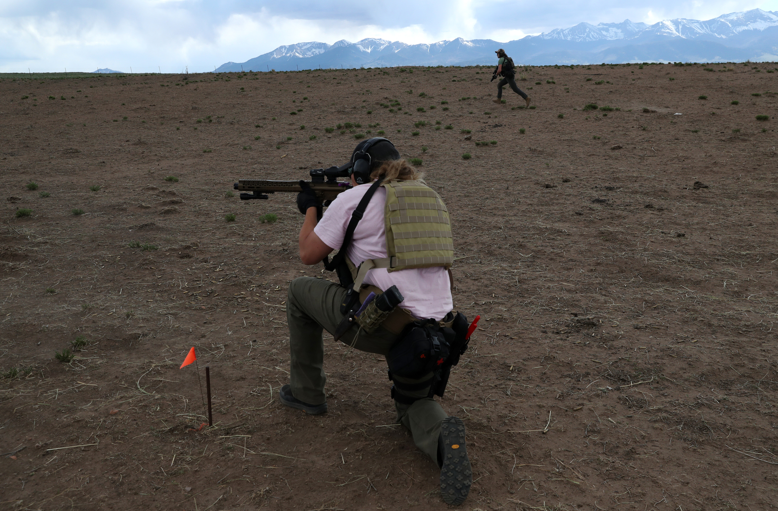 Penny Logue lays down cover fire as J Stanley and Bonnie Nelson run ahead during a live fire drill at their range on the Tenacious Unicorn Ranch in Westcliffe, Colorado. The group say they have stepped up their training since they started receiving death threats and caught armed people on their property. 