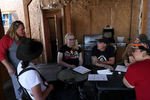 Members of the Tenacious Unicorn Ranch, from left, J Stanley, Kathryn Gibes, Penny Logue, Sky Nelson and Bonnie Nelson greet a woman, who preferred not to give her name, who just moved to the area with a transgender child as they wait for lunch at one of their favorite spots to eat in town, Chappy’s Bar and Grill, in Westcliffe, Colorado.