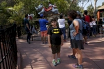 James, 8, expresses his frustration with his mother Sara Kaplan that he is too tall to go on the ride behind him during a family outing to Six Flags amusement park Aug. 20, 2016 in Vallejo, Calif. The prospect of puberty can make James nervous.