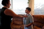 Sara Kaplan helps do her son James', 8, tie as he gets ready for his first day of school August 30, 2016 in Berkeley, Calif. James originally wanted to wear a suit on his first day but his parents talked him down to a polo shirt and tie.