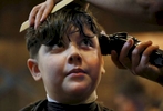 James Kaplan, 9, gets a haircut from Bobby Jean Larrañaga, Feb. 17, 2017 at The Shop in Berkeley, Calif., almost exactly a year after the same hair stylist cut his hair into a {quote}boy style{quote} when he came out as a transgender boy.