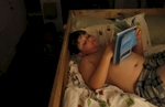 James Kaplan, 8, reads a book for a few minutes before going to sleep Oct. 13, 2016 in Berkeley, Calif. James' father Ben says that right after he transitioned, James became very interested in all of the stereotypical {quote}boy stuff{quote} like batman and comic books. It wasn't until his parents told him it was OK to still like some of the stereotypical {quote}girl things{quote} he still liked from before, like his dolls, that he seemed to level out and feel comfortable having hobbies based on what he liked and not gender stereotypes.