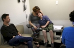 James Kaplan, 9, cries at the prospect of blood work involving needles and is comforted by his mother Sara as his father Ben looks on during a medical appointment with Dr. Ilana Sherer, right, to determine if he is starting puberty March 15, 2017 at UCSF Benioff Children's Hospital's Child and Adolescent Gender Center Clinic in Oakland, Calif. James will be put on hormone blockers to stop the effects of puberty until he is a young teen. If he still insists on his current gender identity, he will then be put on cross-hormone therapy which will allow him to experience development that aligns with his gender identity. 