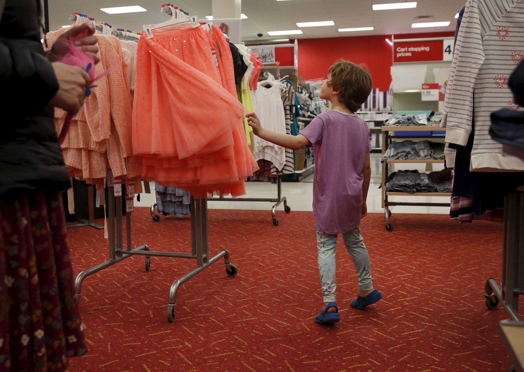 Olivia Kaplan, 4, drifts through the girls' clothing section during a trip to Target to find formal clothes for James Feb. 17, 2017 in Berkeley, Calif. Olivia, James' sibling, had been describing herself as trans for much of the past year since her brother came out as a transgender boy. Sara and Ben decided to brush it off to see if it was just something she was saying to copy her sibling. But it became apparent over time that it was very real to Olivia. She has always been a feminine child and she finally shouted at her parents that she was a girl at the beginning of the year. They cautiously allowed her to begin the transition. As of June, 2017, Olivia is still happily presenting as a girl. Sara and Ben plan on doing what they have for James: provide a supportive space for their children to be themselves whoever they turn out to be later in life.