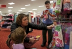 Sara Kaplan, center, picks out her first set of girl panties for Olivia Kaplan, 4, left,  as James, 9, examines a bra during a trip to Target to find formal clothes for James Feb. 17, 2017 in Berkeley, Calif. Olivia, James' sibling, had been describing herself as trans for much of the past year since her brother came out as a transgender boy. Sara and Ben decided to brush it off to see if it was just something she was saying to copy her sibling. But it became apparent over time that it was very real to Olivia. She has always been a feminine child and she finally shouted at her parents that she was a girl at the beginning of the year. They cautiously allowed her to begin the transition. As of June, 2017, Olivia is still happily presenting as a girl. Sara and Ben plan on doing what they have for James: provide a supportive space for their children to be themselves whoever they turn out to be later in life.