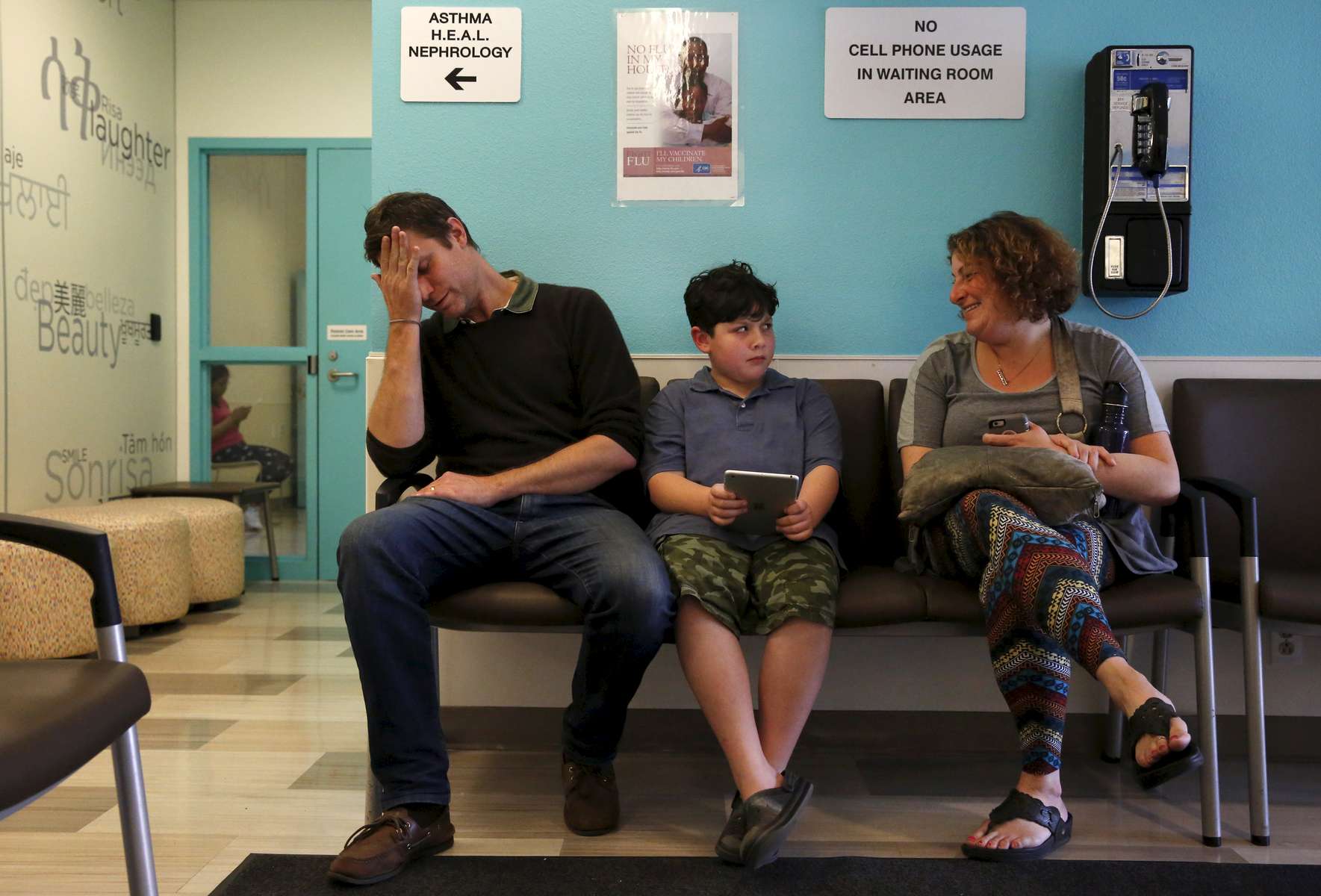 James Kaplan, 9, center, and his father Ben react to a puberty joke made by his mother Sara, right, as they wait for James' medical appointment  to determine if he is starting puberty March 15, 2017 at UCSF Benioff Children's Hospital's Child and Adolescent Gender Center Clinic in Oakland, Calif. James will be put on hormone blockers to stop the effects of puberty until he is a young teen. If he still insists on his current gender identity, he will then be put on cross-hormone therapy which will allow him to experience development that aligns with his gender identity. 