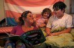 Sara Kaplan reads a bedtime story to her children Olivia, 5, center, and James, 9, in Berkeley, Calif. Olivia, James' sibling, had been describing herself as trans for much of the past year since her brother came out as a transgender boy. Sara and Ben decided to brush it off to see if it was just something she was saying to copy her sibling. But it became apparent over time that it was very real to Olivia. She has always been a feminine child and she finally shouted at her parents that she was a girl at the beginning of the year. They cautiously allowed her to begin the transition. As of June, 2017, Olivia is still happily presenting as a girl. Sara and Ben plan on doing what they have for James: provide a supportive space for their children to be themselves whoever they turn out to be later in life.