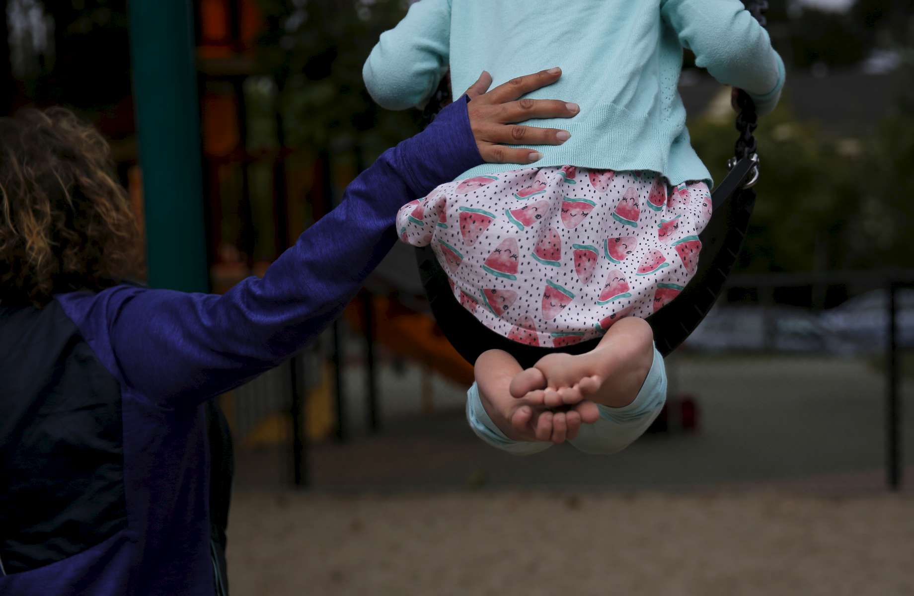 Sara Kaplan pushes her daughter Olivia, 5, on the swing as Olivia and James play in the park while they wait to get haircuts June 3, 2017 in Berkeley, Calif. Olivia, James' sibling, had been describing herself as trans for much of the past year since her brother came out as a transgender boy. Sara and Ben decided to brush it off to see if it was just something she was saying to copy her sibling. But it became apparent over time that it was very real to Olivia. She has always been a feminine child and she finally shouted at her parents that she was a girl at the beginning of the year. They cautiously allowed her to begin the transition. As of June, 2017, Olivia is still happily presenting as a girl. Sara and Ben plan on doing what they have for James: provide a supportive space for their children to be themselves whoever they turn out to be later in life.