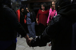 Maria Mendoza-Sanchez, center right, bows her head as her friend Tina Chaney, far right, leads a group prayer in the Sanchez living room with Vianney Sanchez, 23, left, Veronica Perez and other family and friends before the group left to see Maria, Eusebio and Jesus off to Mexico for their ordered self-deportation from SFO August, 16, 2017 in Oakland, Calif.