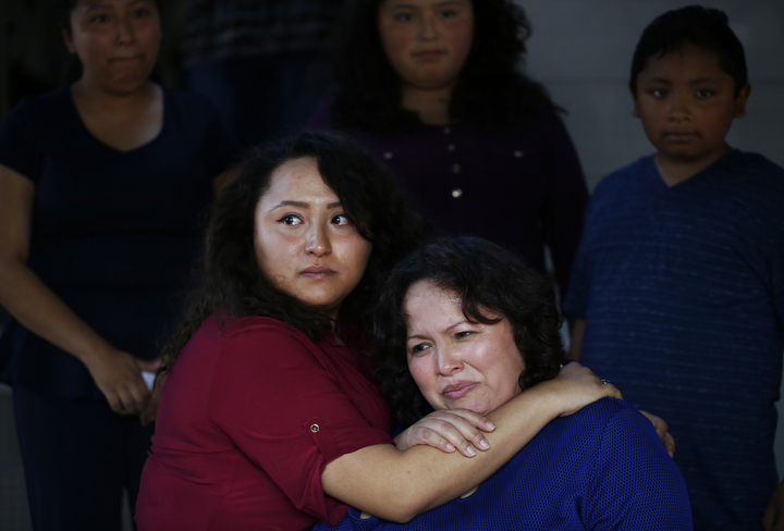 With tears in her eyes, Vianney Sanchez, 23, left, comforts her mother Maria Mendoza-Sanchez after a meeting the family had with Sen. Dianne Feinstein at the Sanchez home as siblings, from left, Melin Sanchez, 21, Elizabeth Sanchez, 16, and Jesus Sanchez, 12 look on August 10, 2017 in Oakland, Calif.