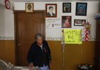 Eusebio's mother, Guadalupe Mejia Sanchez, 78, walks past welcome home signs for Eusebio, Jesus and Maria posted in her living room Sept. 27, 2017 in Santa Monica, Hidalgo, Mexico. The signs are leftover from about a month previously, when the three first arrived in Mexico after they were deported from Oakland.