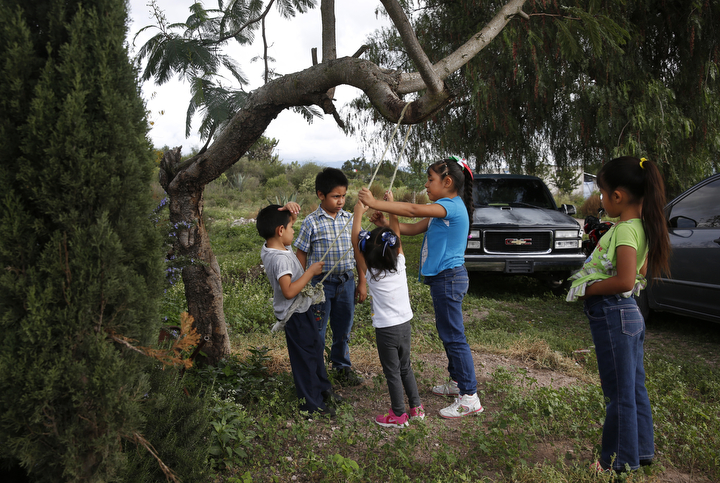 Children have a swing disagreement during a family christening party Sept. 28, 2017 near Santa Monica, Hidalgo, Mexico. Maria says family gatherings are bitter-sweet because she hasn't seen or even met many of them but they remind her that she is separated from her children. 