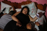 Maria Mendoza-Sanchez and her son Jesus Sanchez, 12, video chat with Jesus' sisters as his father Eusebio Sanchez sleeps next to them before bed in their room which is normally Maria's mother's room in her mother's home Sept. 28, 2017 in Santa Monica, Hidalgo, Mexico. Maria calls her daughters at least once a day every evening to check in on how their days were and to tell them about their lives in Mexico. Maria later sent Jesus back to Oakland because his paperwork did not come through in time at the local school and he would have been held back a year.