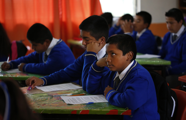 Jesus Sanchez, 12, right, listens to the teacher read literature with his cousin Francisco Mejia, 13, left center, at school Oct. 2, 2017 in Santa Monica, Hidalgo, Mexico. School has been very difficult for Jesus to adjust to because Spanish is not his first language and the teacher is much more strict than US teachers are allowed to be. Much of the time, Jesus relies on his cousin to help him translate.