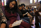 From left, siblings Elizabeth, 16, Melin, 21, Jesus, 12, and Vianney Sanchez, 23, follow the service at their local Catholic church Nov. 5, 2017 in Oakland, Calif. When their parents left Vianney promised their mother that they would attend church services every Sunday and they have, finding a supportive community there. Their mother Maria Mendoza-Sanchez made the decision to send Jesus back to the US after it was discovered that his paperwork hadn't gone through quickly enough for school and he would have to repeat the entire grade over again.