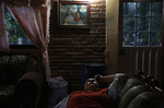 Maria Mendoza-Sanchez lays on a chair, staring at the ceiling of her mother's home as rain falls unrelenting outside, keeping the internet and phone service from working, cutting her off from communication with her daughters Oct. 1, 2017 in Santa Monica, Hidalgo, Mexico. The phone service is very unreliable in the small town Maria now lives in and weather even as benign as high winds can take out the home's internet connection, cutting them off from the outside world. Many days Maria says she simply stares out the window, thinking of her children, her heart aching, wishing she was with them.