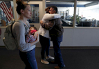 Columbine high school alumni Rachel Burr, center, and Tami Diaz (holding Alayna, 6 wks) say good bye to retired principal Frank DeAngelis after a group of former students and survivors took a private tour of the school March 17, 2018 in Littleton, Colorado, US. 