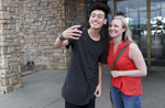 Mass shooting survivors Carlitos Rodriguez, 17, of Marjory Stoneman Douglas poses for a selfie with Heather Martin of Columbine July 24, 2018 outside of a restaurant after they had lunch in Lone Tree, Colorado, US.