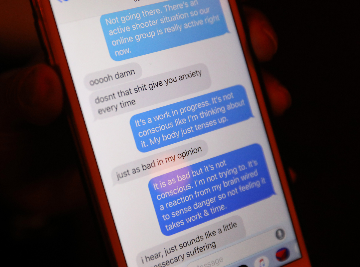 Sherrie Lawson, a survivor of the Washington Navy Yard shooting texts with a friend about news that day of the shooting in Aurora, IL, as she hangs out at the Horseshoe Lounge February 15, 2019 in Denver, Colorado, US. 
