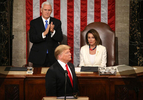 Speaker of the House Nancy Pelosi (D-CA) reacts alongside Vice President Mike Pence as he applauds U.S. President Donald Trump during his second State of the Union address to a joint session of the U.S. Congress in the House Chamber of the U.S. Capitol on Capitol Hill in Washington, U.S. February 5, 2019. 