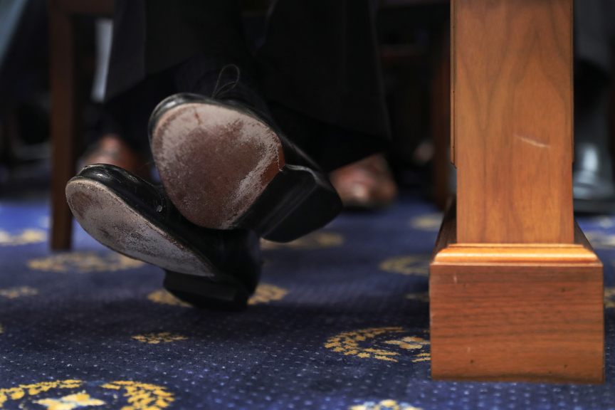 The shoes of former Special Counsel Robert Mueller are seen as he testifies before a House Intelligence Committee hearing on the Office of Special Counsel's investigation into Russian Interference in the 2016 Presidential Election{quote} on Capitol Hill in Washington, U.S., July 24, 2019. REUTERS/Leah Millis