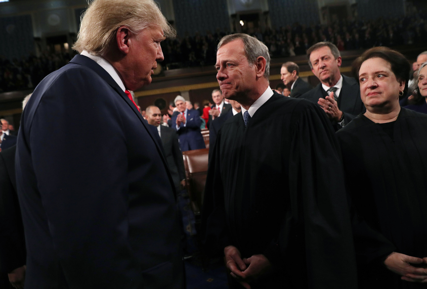 U.S. President Donald Trump talks to Supreme Court Chief Justice John Roberts while Associate Justice Elena Kagan looks on as the president arrives to U.S. President Donald Trump delivers his State of the Union address to a joint session of the U.S. Congress in the House Chamber of the U.S. Capitol in Washington, U.S., February 3, 2020. REUTERS/Leah Millis/POOL