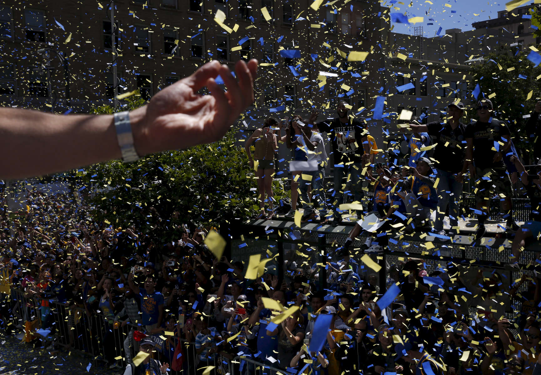 JaVale McGee takes in the scene as thousands of fans cheer during the Warriors' 2017 NBA Championship parade June 15, 2017 in Oakland, Calif.