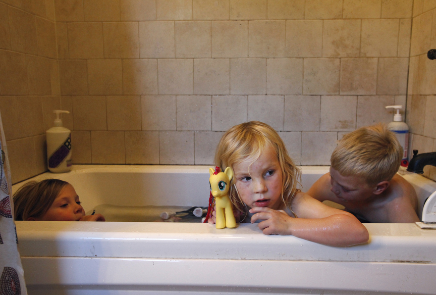 From left, Markegard siblings Quill, 6, Quince, 4, and Larry, 7, take their weekly bath together to save water in their family home Nov. 4, 2014 in Half Moon Bay, Calif. The Markegards started their grass-fed business nine years ago on 1,000 acres of land they’ve leased for years in Half Moon Bay. As the drought worsened this year, they saw their 16 water sources shrink to just one. They’ve had to move their 4-500 head of cattle to land leased off the property because all of the water sources on their land have dried up, including the spring that used to provide water for their home. Now they have to haul in water for their family once about every three weeks. “We watch every drop,” said Doniga about their water conservation.
