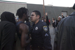 A police officer and a protester have a tense moment before a scuffle breaks out between a different protester and police officers near the port during an {quote}F the Police{quote} march held in solidarity with Ferguson, Mo., where there was a fatal shooting of an unarmed 18-year-old black man earlier in the week August 15, 2014 in Oakland, Calif. 
