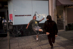 Ralph Guerra, 53, runs off a protester after the person tried to spray paint on a window during an {quote}F the Police{quote} march held in solidarity with Ferguson, Mo., where there was a fatal shooting of an unarmed 18-year-old black man earlier in the week August 15, 2014 in Oakland, Calif. 