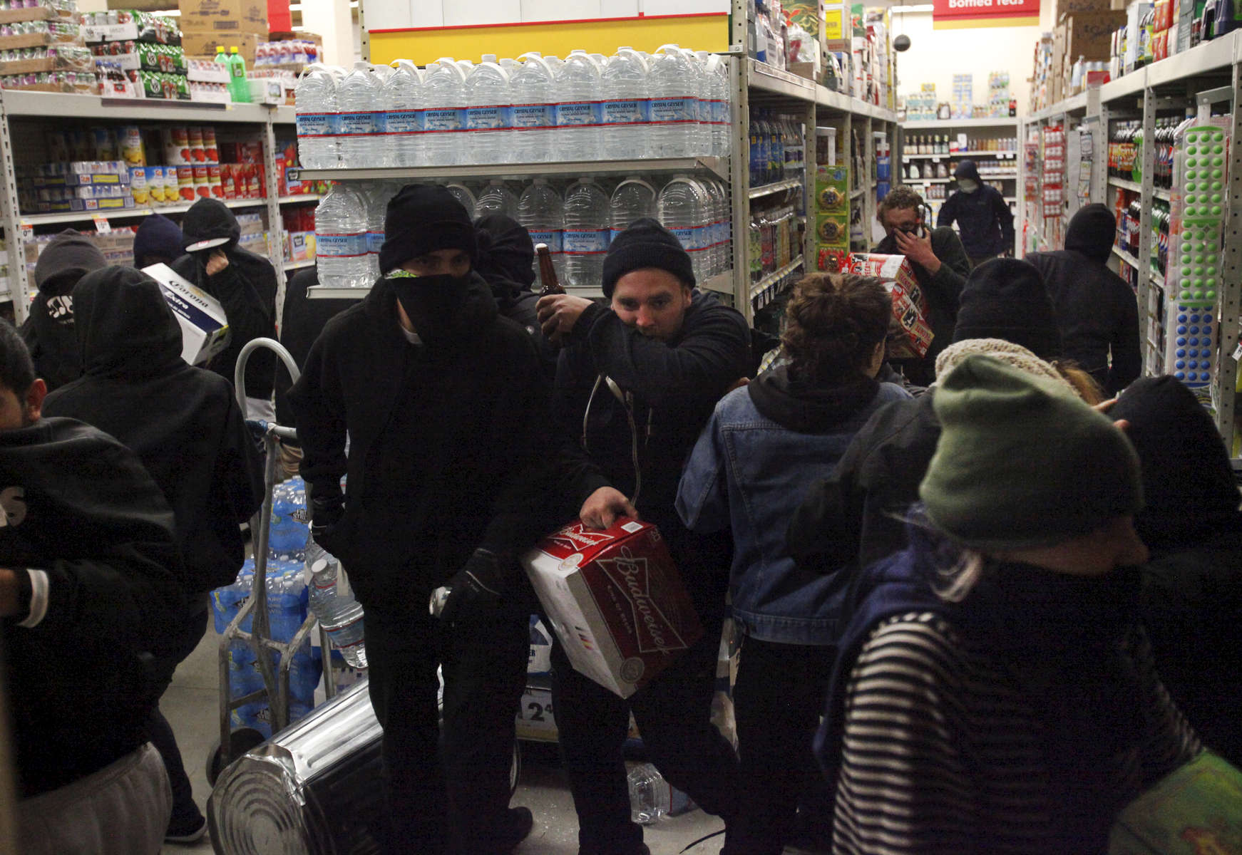 Protesters loot the grocery store Smart and Final after some vandalized the front and broke the windows during a protest against the grand jury's decision not to indict the white police officer who fatally shot an unarmed black teenager months ago in Ferguson Nov. 24, 2014 in Oakland, Calif.