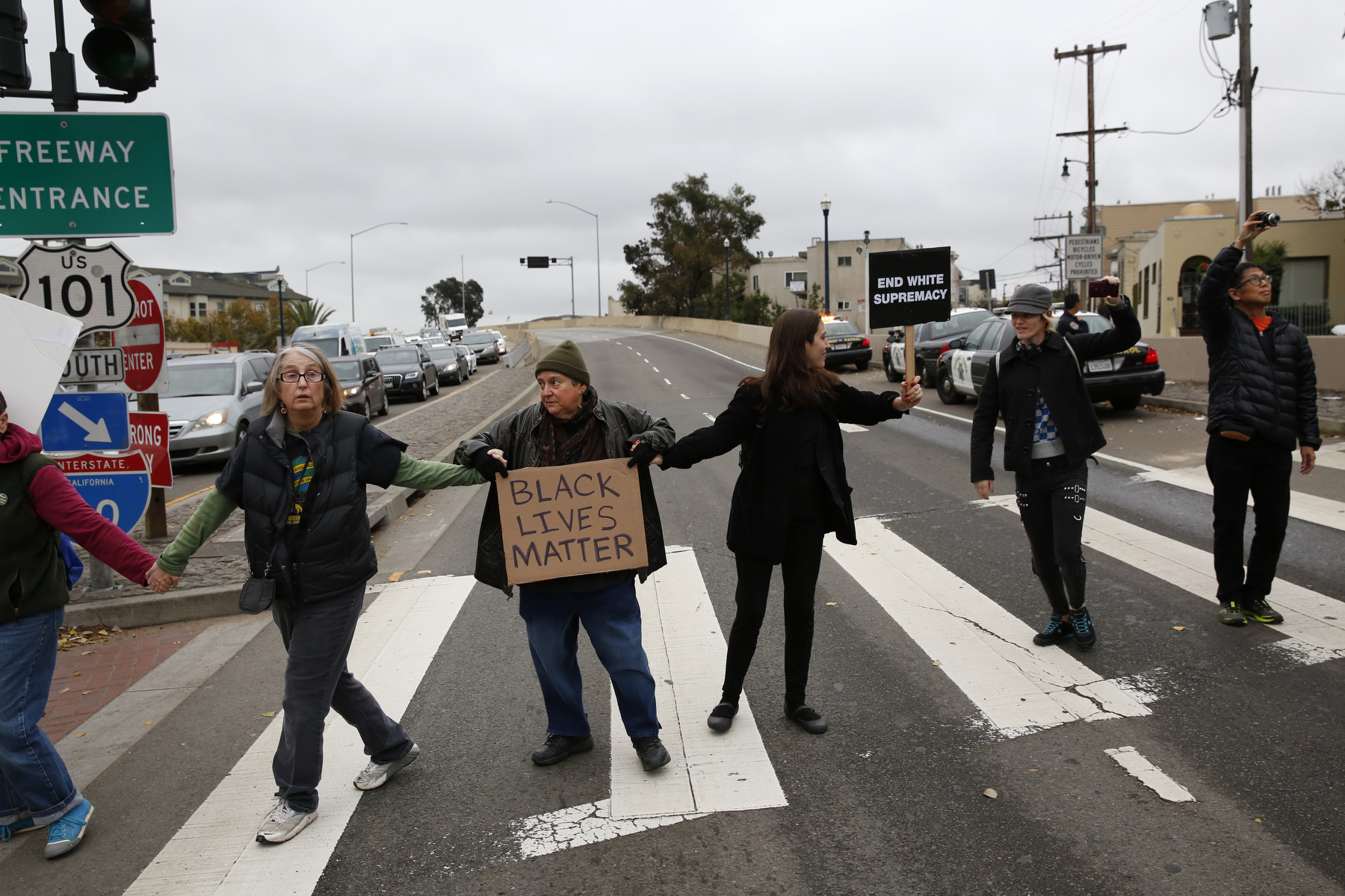 People hold hands and block the 101 south freeway entrance and exit ramps at the intersection of Octavia and Market streets during a {quote}LGBT Rally and March for an End to Police Violence{quote} Dec. 24, 2014 in San Francisco, Calif. 