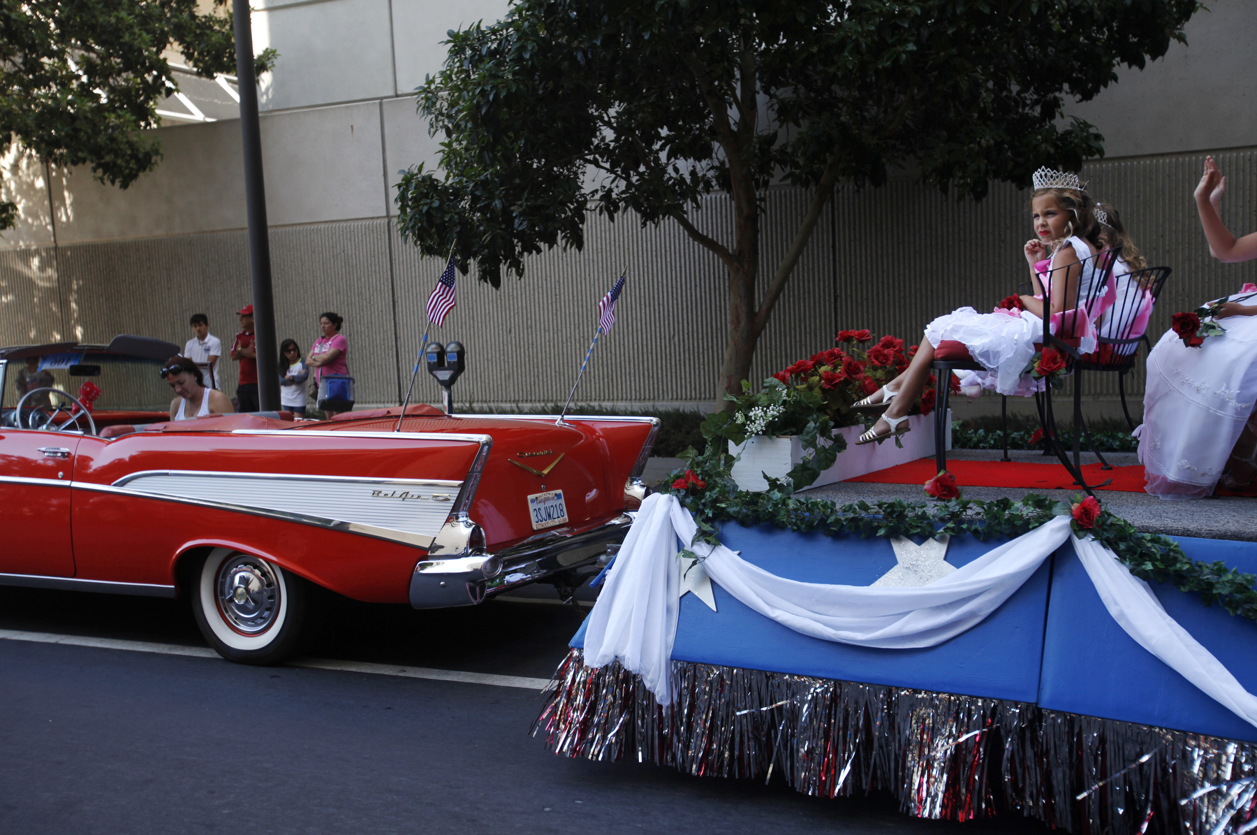 Josie Hussussian, 6, front right, sits with others in the Redwood City, San Mateo County Princess Program members, as they practice their waves before the annual Fourth of July Parade July 4, 2014 in downtown Redwood City, Calif. The parade is the largest and oldest fourth of July parade in the bay area.