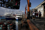 Dock workers, from left, Virginia Flores, Martha Bustamante and Ingrid Orecaba operate a hoist to help the Ingot load up crab traps or {quote}pots{quote} on Pier 45 Nov. 14, 2014 as the crab season starts in San Francisco, Calif.