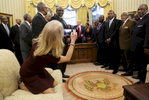 Counselor to the President Kellyanne Conway takes a picture of U.S. President Donald Trump with members of the Historically Black Colleges and Universities in the Oval Office of the White House.
