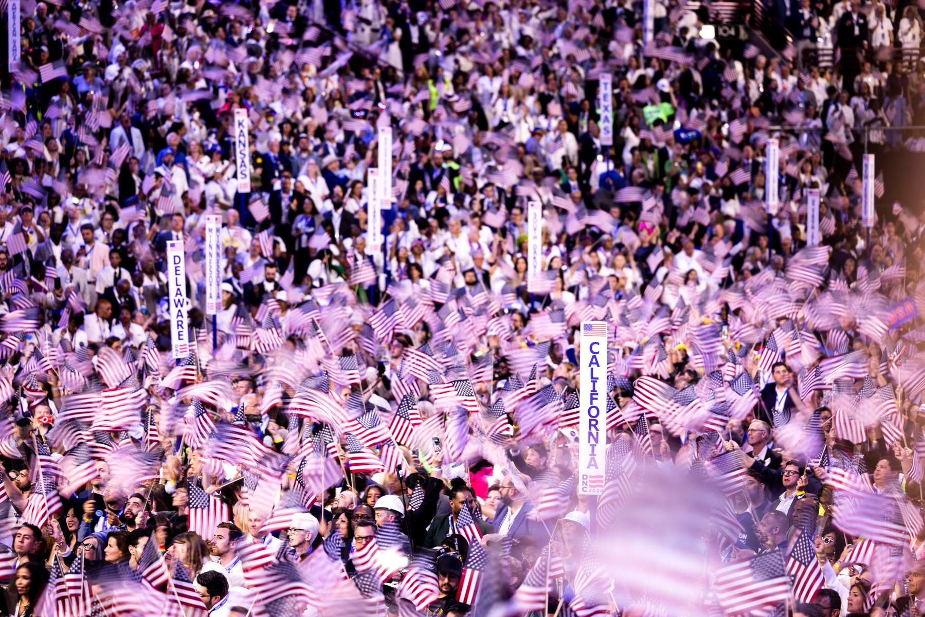 Delegates wave flags during the fourth day of the the Democratic National Convention (DNC) at the United Center in Chicago, Illinois, US, on Monday, August 22, 2024. The 2024 Democratic National Convention, held from 19 to 22 August 2024, is when delegates of the United States Democratic Party will select the party's nominees for president and vice president in the 2024 United States presidential election.  MAXPPP/AUDE GUERRUCCI