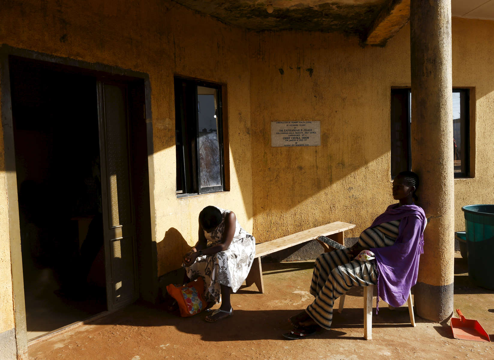 Pregnant women wait outside of the medical facility of Kuchigoro in Abuja, Nigeria.