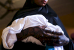 A mother holds her sick child during a medical appointment, at the medical facility of Kuchigoro in Abuja, Nigeria.