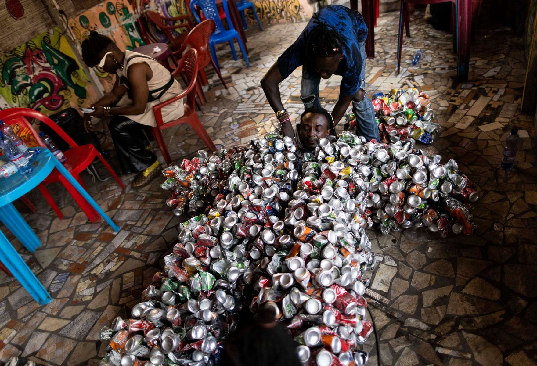 Eddy Ekete puts on his costume before a performance in the streets of Kinshasa.