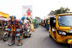 {quote}Ndaku ya La vie est belle{quote} members walk in the streets of Kinshasa during a performance.