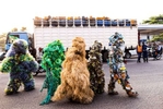 {quote}Ndaku ya La vie est belle{quote} members walk in the streets of Kinshasa during a performance.