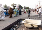 {quote}Ndaku ya La vie est belle{quote} members walk in the streets of Kinshasa during a performance.