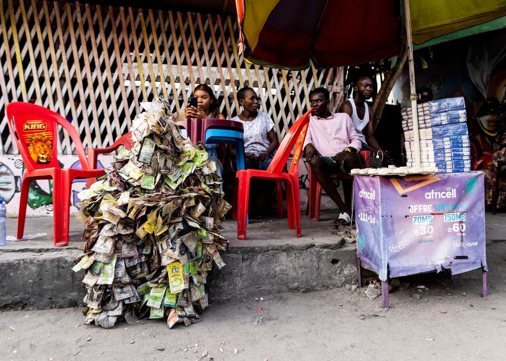 {quote}Ndaku ya La vie est belle{quote} member sits in between during a performance in the streets of Kinshasa.