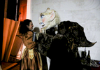 Actress Melodie Veillard plays with Thierry Peteau, playing the ogre backstage during a show.