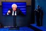 07252016 - Philadelphia, Pennsylvania, USA - Senator Bernie Sanders (I-VT) address the delegates, seen on a TV screen, while woman translates the speech for non-hearing people, on the first day of the Democratic National Convention at the Wells Fargo Center. 
