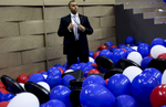 A Secret service agent stands in the balloons at the end of the DNC