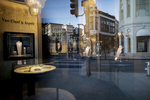 An almost empty Rodeo Drive is reflected on the closed Van Cleef & Arpels window store, in Beverly Hills on March 27, 2020. Governor Gavin Newsom issues a {quote}stay at Home{quote} order on March 19, to slow the spread of Covid-19, closing all the non-essential businesses which include luxury stores. 