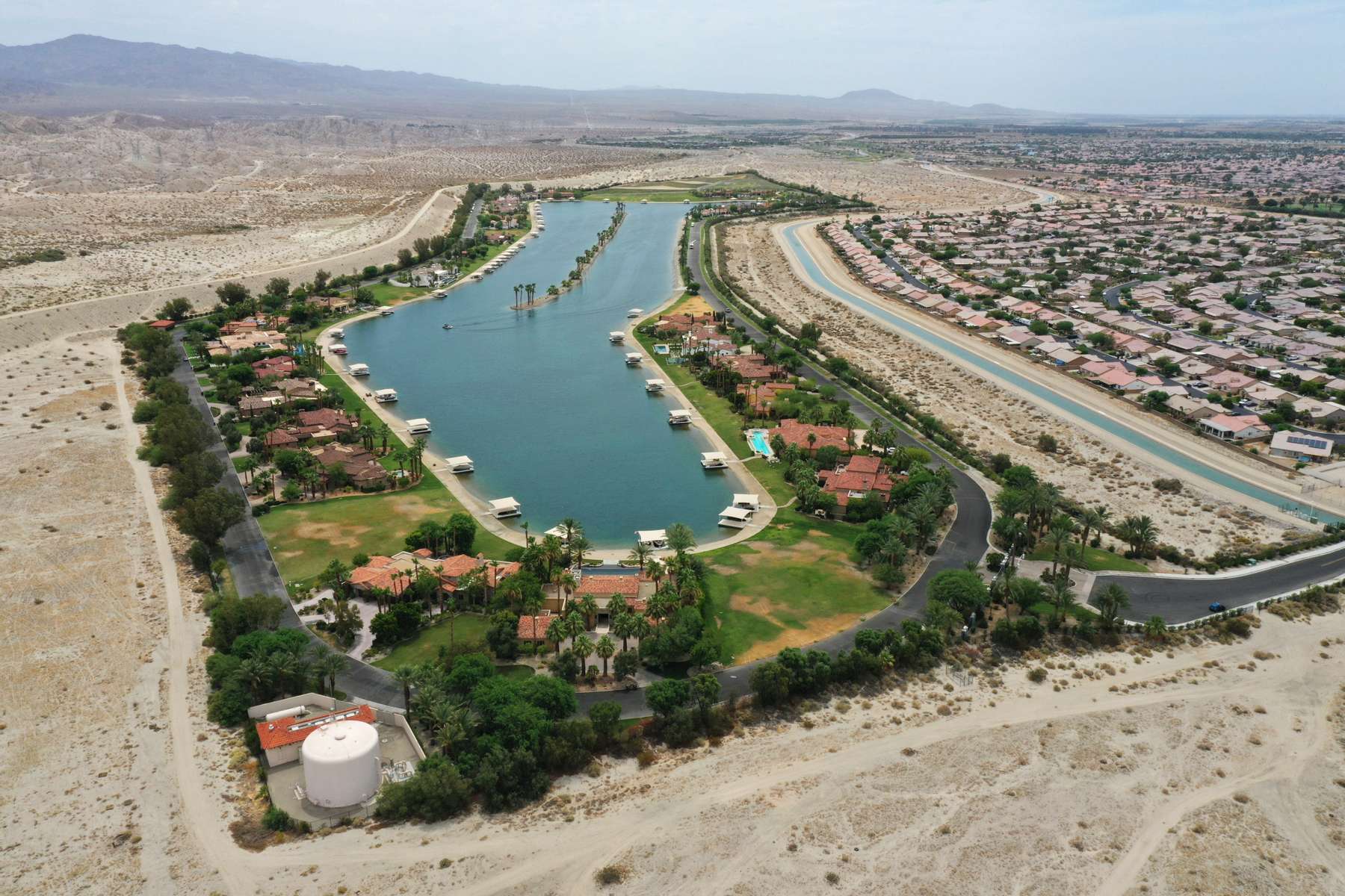 An aerial view shows the artificial lake, Shadow Lake Estates, next to desert landscape as California faces its worst drought since 1977, in Palm Springs, California, U.S., June 29, 2021. Picture taken with a drone June 29, 2021.